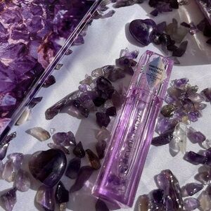BUY NOW Makeup Revolution crystal aura lip oil with Amethyst crystal inside.